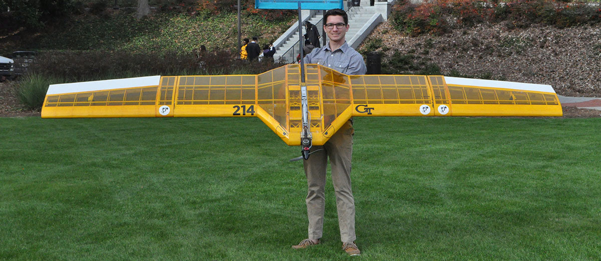 Frank Kozel standing with BUzz Bomber the award-winning prototype he's worked on with the SAE club