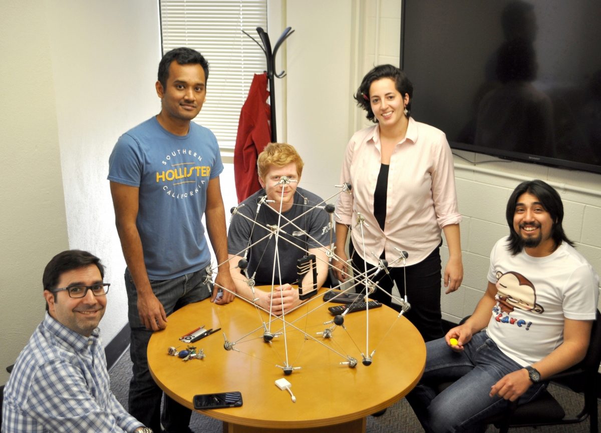 Christine Gebara and three other students work with Prof. Rimoli  on a tensegrity