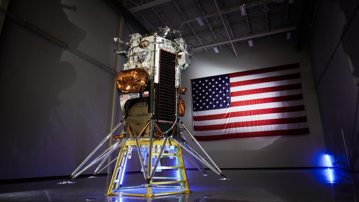 IM-1 Nova-C lander completed assembly with an American flag in the background. 