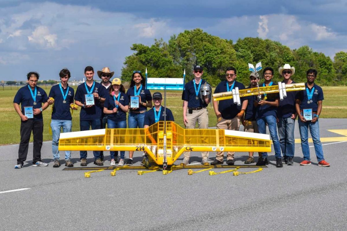 Students from the ASDL stand with their two airplanes at the SAE Competition in Lakeland Florida