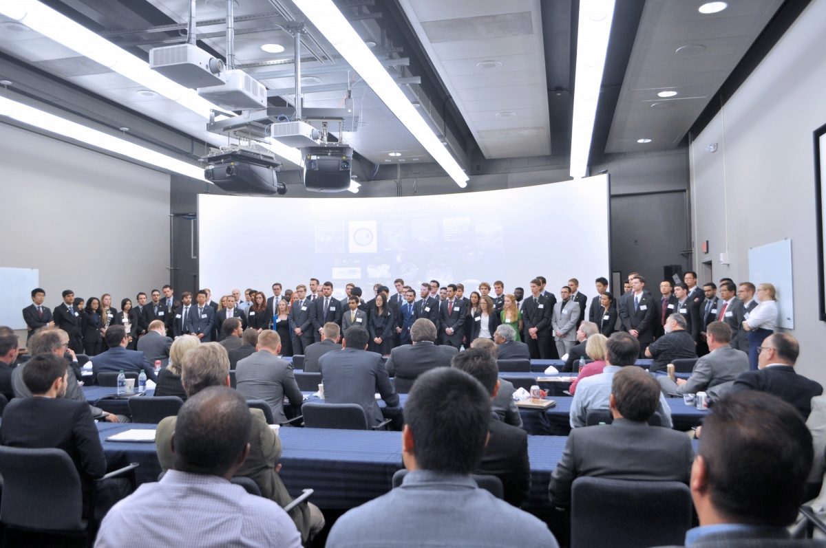 About 100 student engineers lined up at the front of the room, listening to sponsors' advice