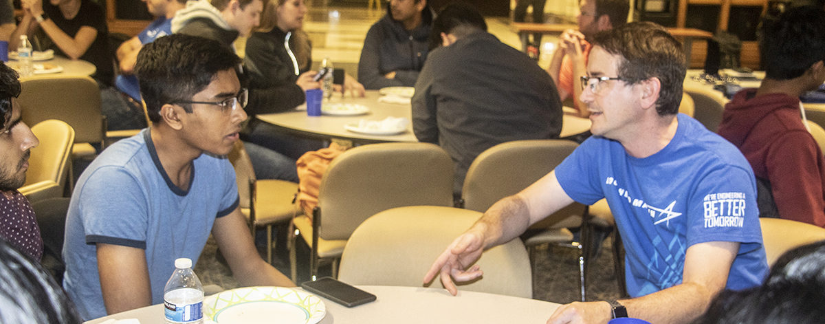 Lockheed Martin engineer Javier Jimenez talking with one of the AE students during the Lockheed Martin Challenge