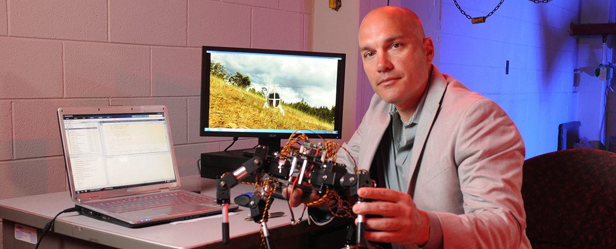 Prof. Costello next to his computer in the CAMM Lab