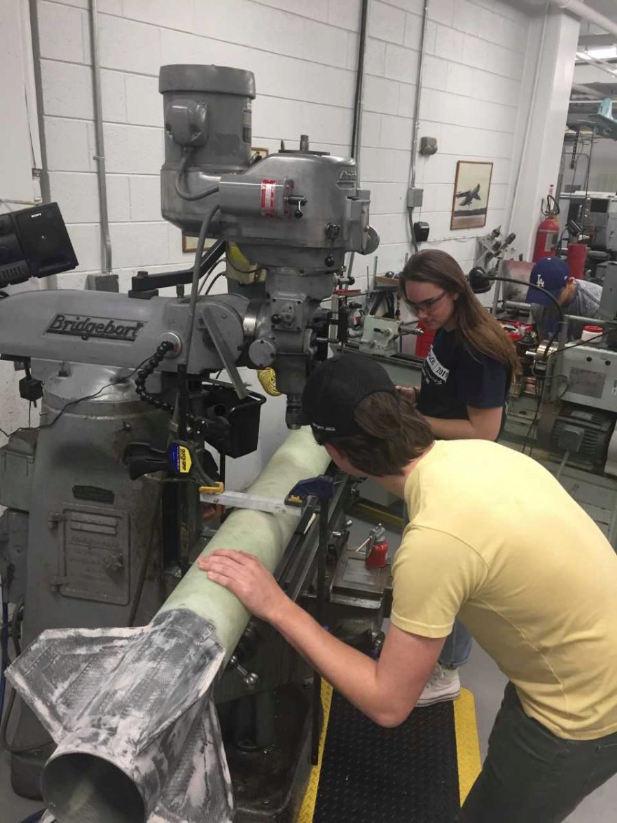 Rachel Thomas and Sawyer Flanagan working on a mill