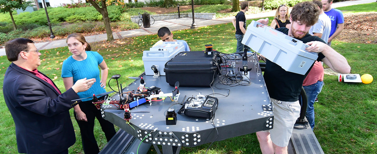 Aerospace Engineering School Researcher Kelly Griendling consulting with ASDL Directore Dimitri Mavris while students construct a vehicle