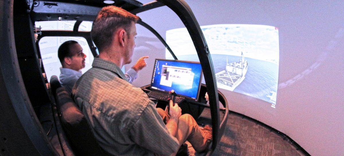 Dev Minotra and Bob Walters behind the wheel of the Bell OH58 simulator