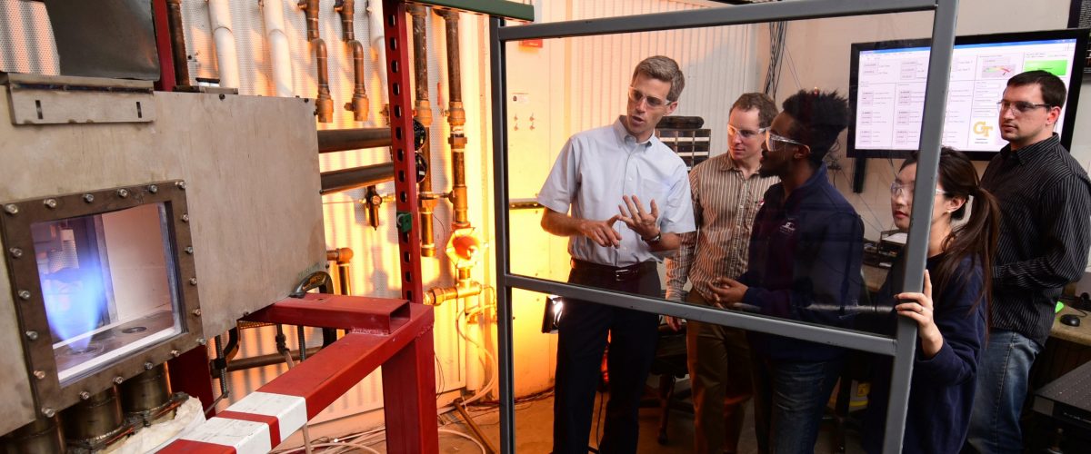 Lieuwen reviewing lab protocol in the combustion lab with grad students