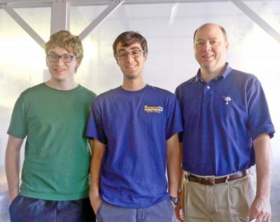 Students Kyle Scott, John Amin, join Dr. E. Glenn Lightsey for the final packaging of Prox 1