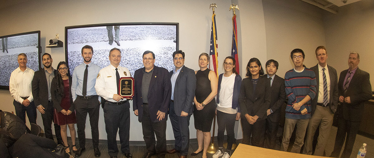 The ASDL Team standing with the police chief at the Awards Ceremony