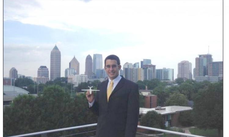 <p><em><strong>Tom Neuman, MSAE '15, is seen here with a model of The Vapor, the hydrogen fuel cell-powered plane he designed for the NASA University Design Challenge: All Electric Aviation Vehicle competition.</strong></em></p>