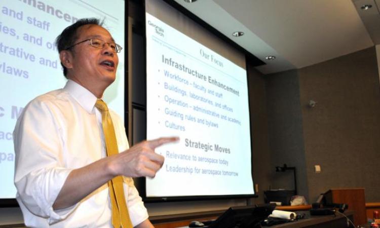 <p>Photo of Dr. Yang giving a talk</p>