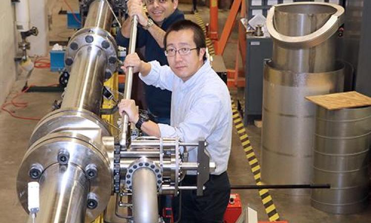 <p>Dr. Wenting Sun, foreground, is seen here with doctoral student Miad Karmini, working on the new Shock Tube that was installed in the Ben T. Zinn Combustion lab this year.</p>