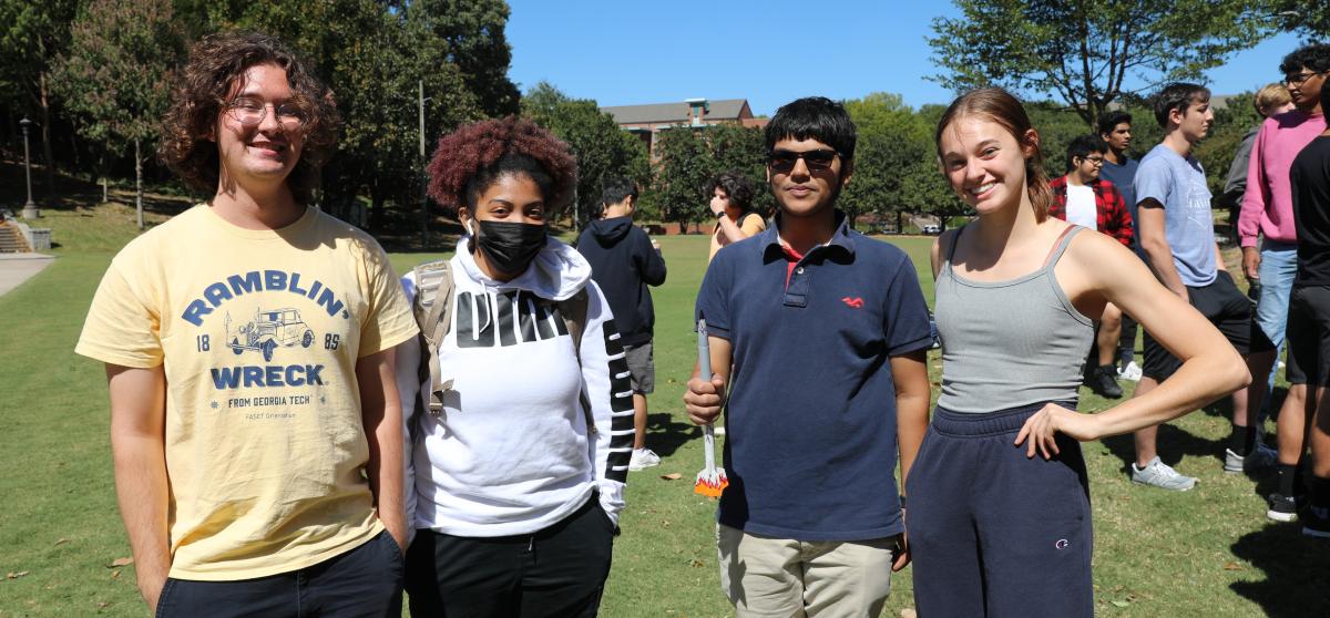 students smiling with their rocket during the AE 1601 rocket launch.