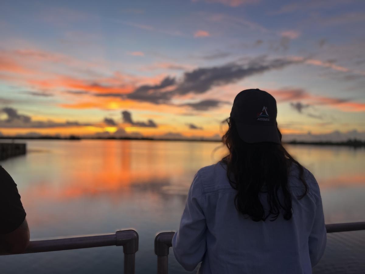 Kelsey Gulledge looks out over the launch site as the sunrises over Cape Canaveral