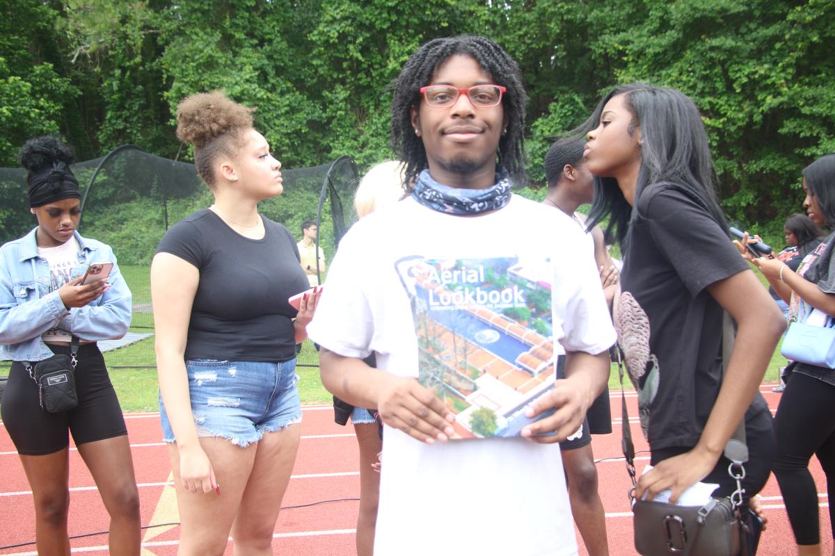 STUDENT HOLDING BOOK