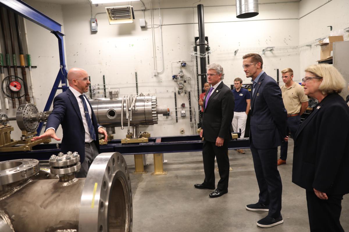 NASA Deputy Adminstrator and House of Representatives members visit Georgia Tech , shown walking with Mitchell Walker