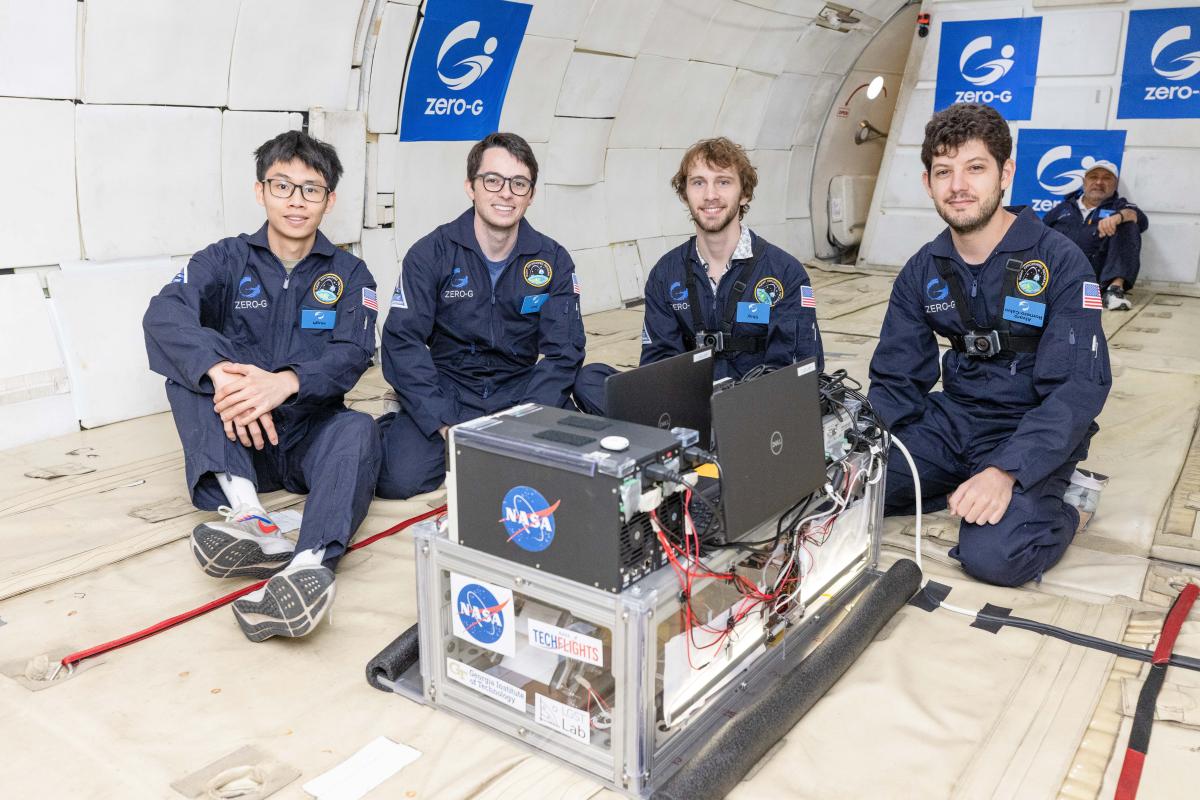 The crew poses with their experiments before taking off