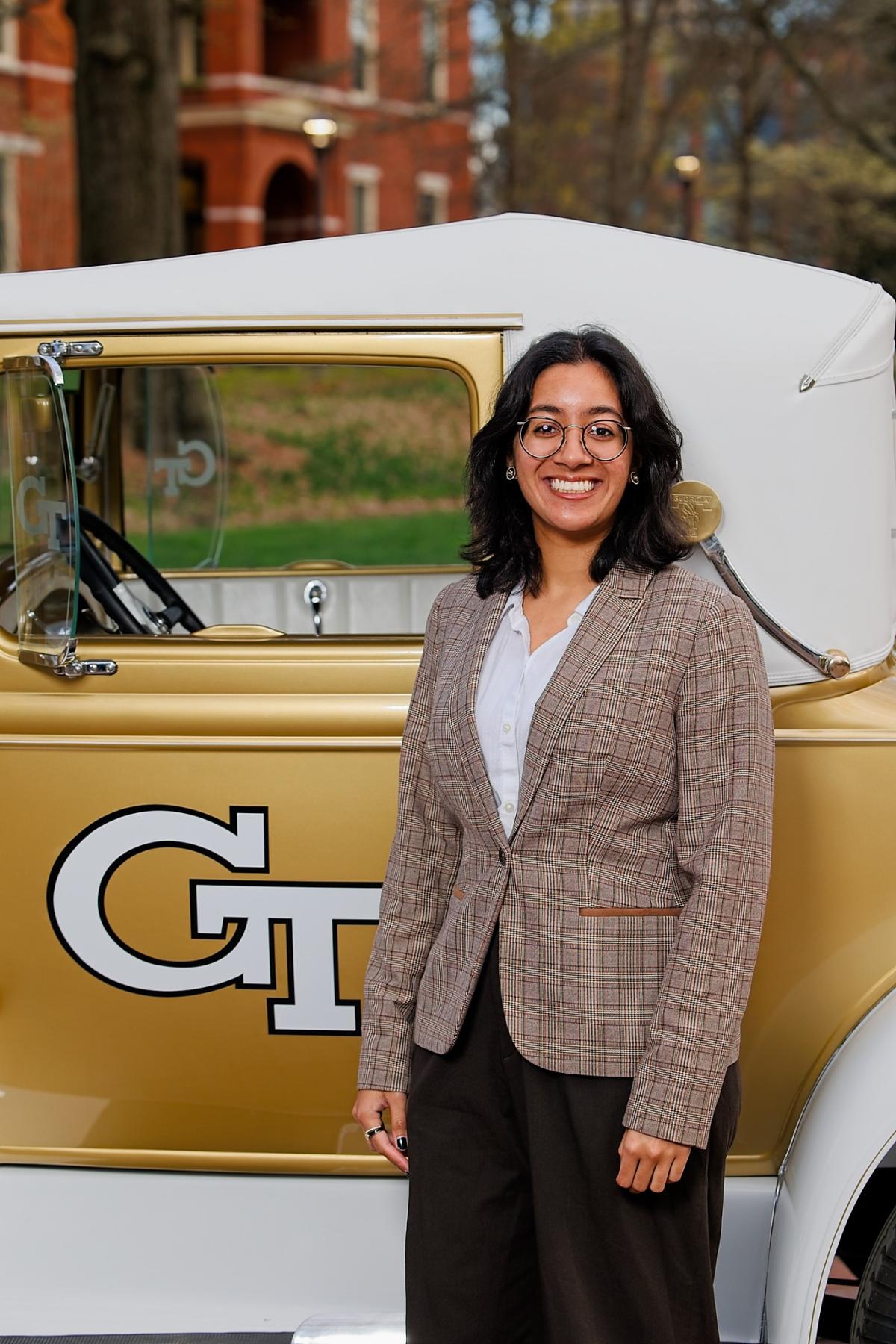 Ishani Peddi proudly stands next to the ramblin reck