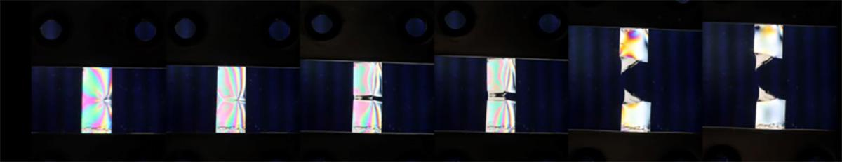 photoelastic images showing how forces concentrate around a growing crack in material.